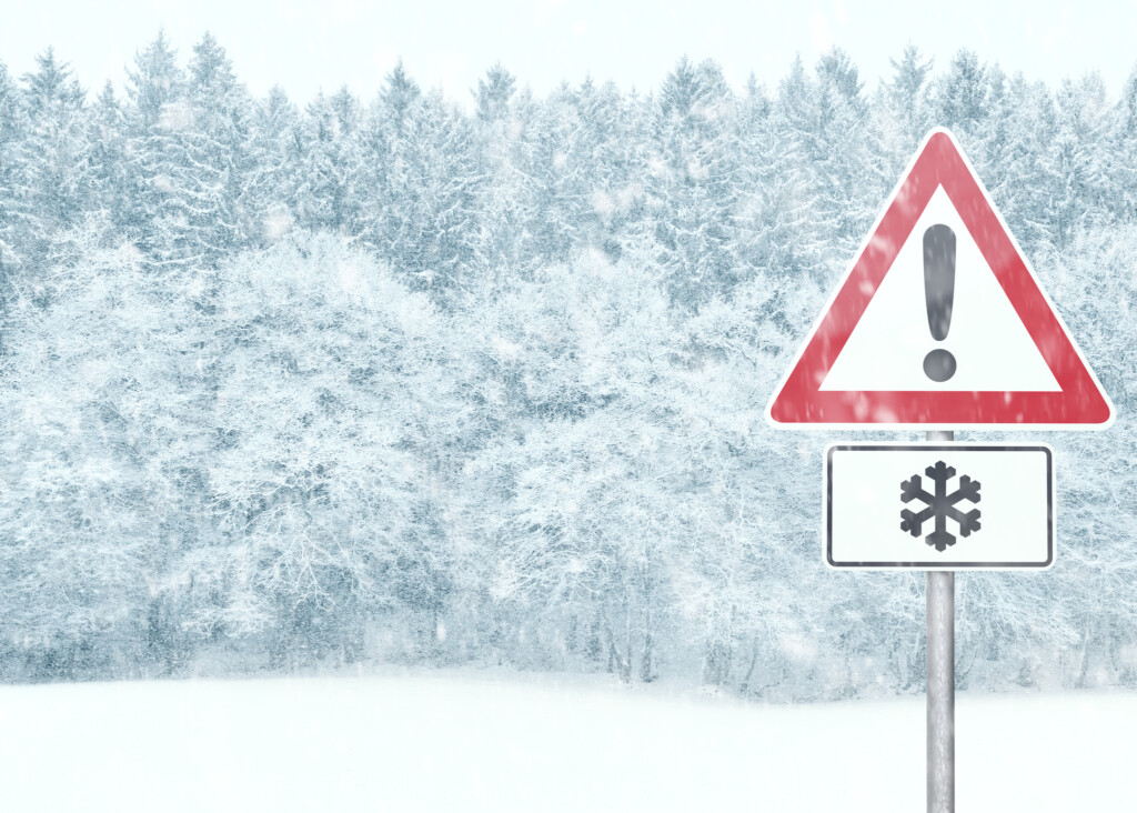 Snowy landscape with warning sign and copy space