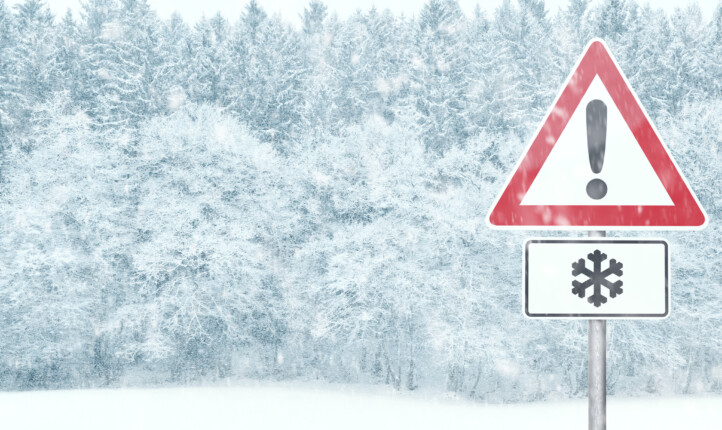 Snowy landscape with warning sign and copy space